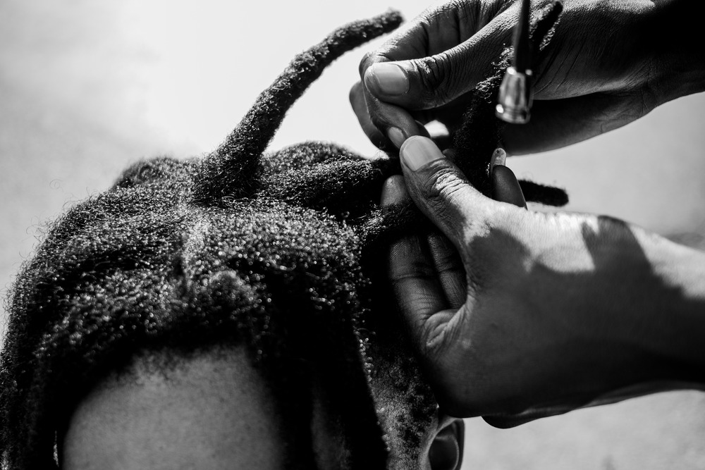 A man with dreadlocks being done